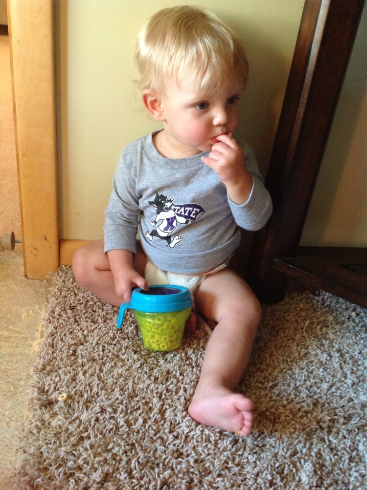Little man sitting underneath the radio listening to what's going on in the field.
