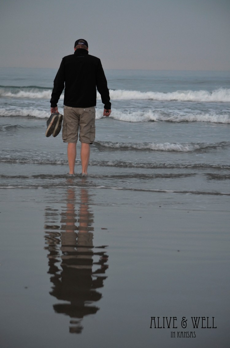 Getting his feet wet in the Pacific for the first time.